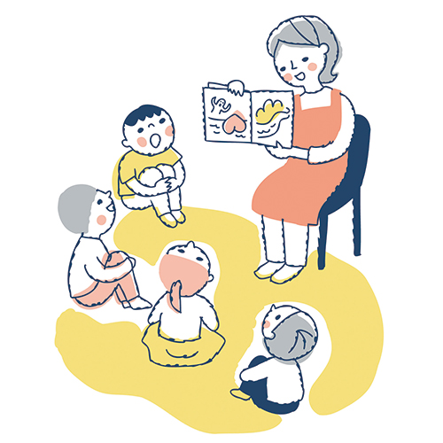 絵本の読み聞かせをする人と周りで聞いている子どもたち