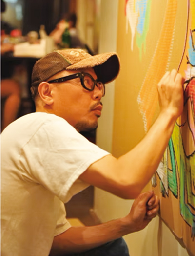 絵を描いている門秀彦氏